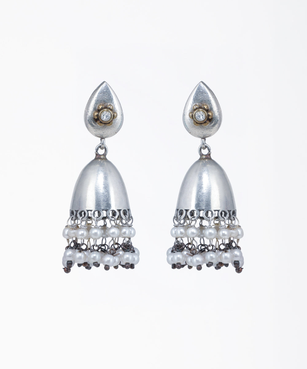 Oxidized silver-tone jhumka earrings with a teardrop stud, gold-tone floral accent, clear stone, and tiered faux pearls.
