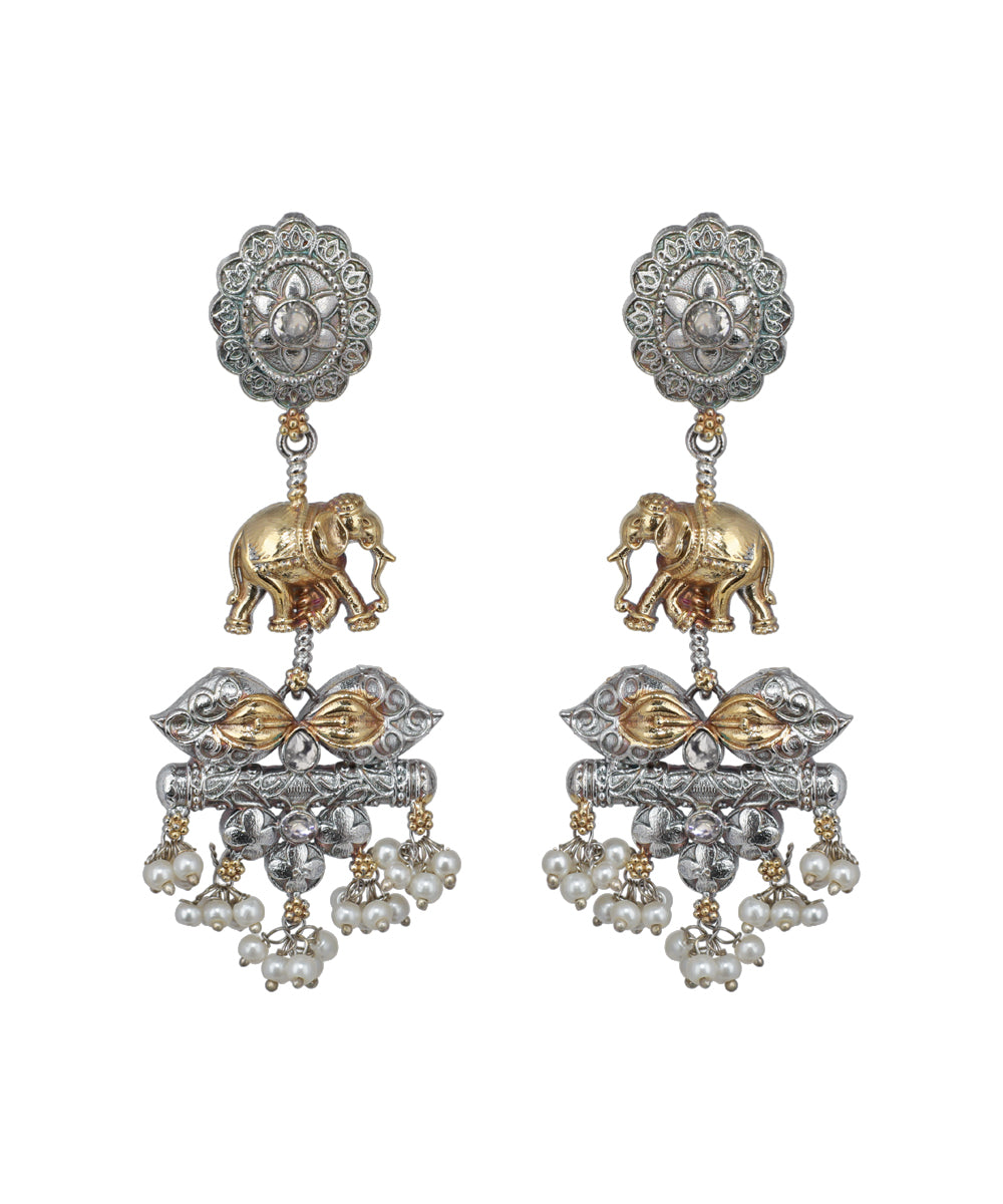 Ornate earrings with elephants and pearl-like beads on a white background