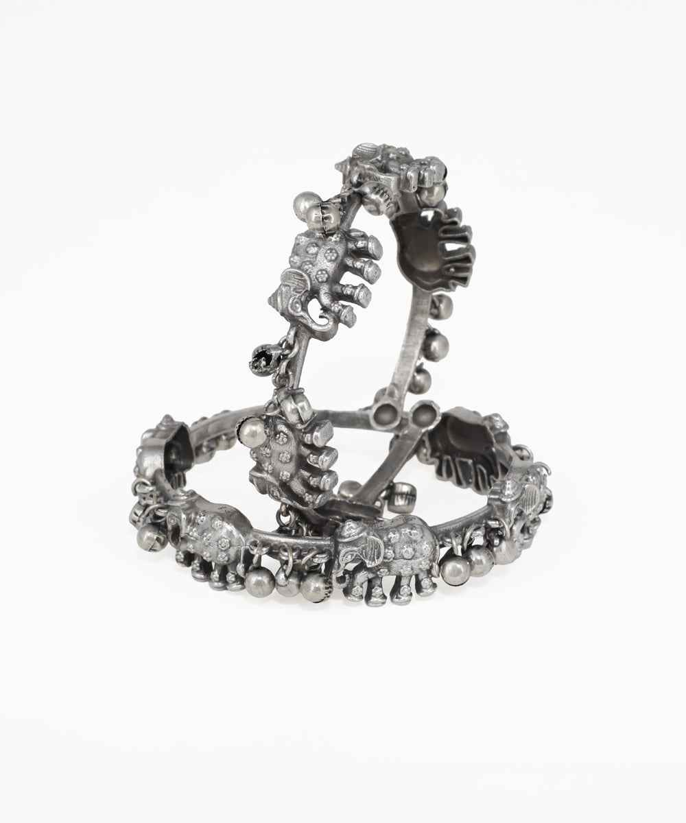 Silver bracelet with floral design on a white background