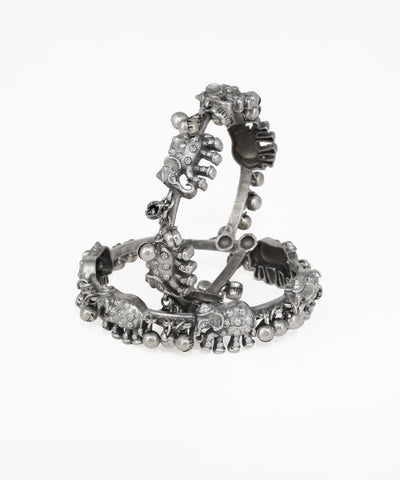 Silver bracelet with floral design on a white background