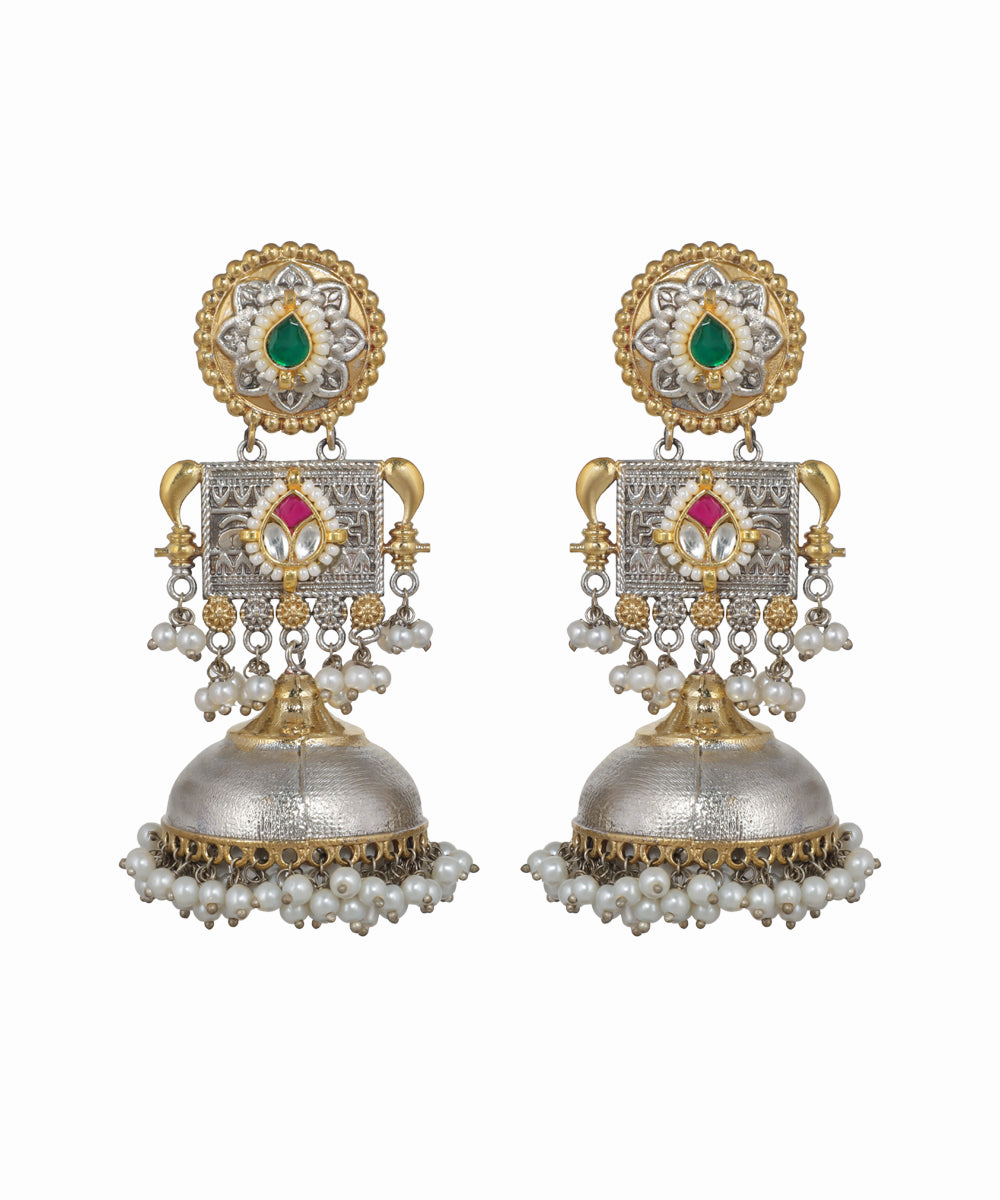 Pair of ornate earrings with gold, silver, and gemstone details on a white background