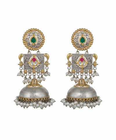 Pair of ornate earrings with gold, silver, and gemstone details on a white background