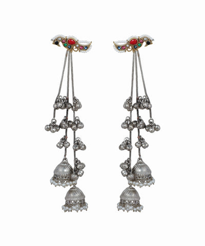 Pair of silver earrings with hanging bells and gemstone accents on a white background