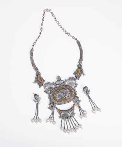 Silver-tone and gold-tone necklace set with intricate floral motifs and faux pearl drops
