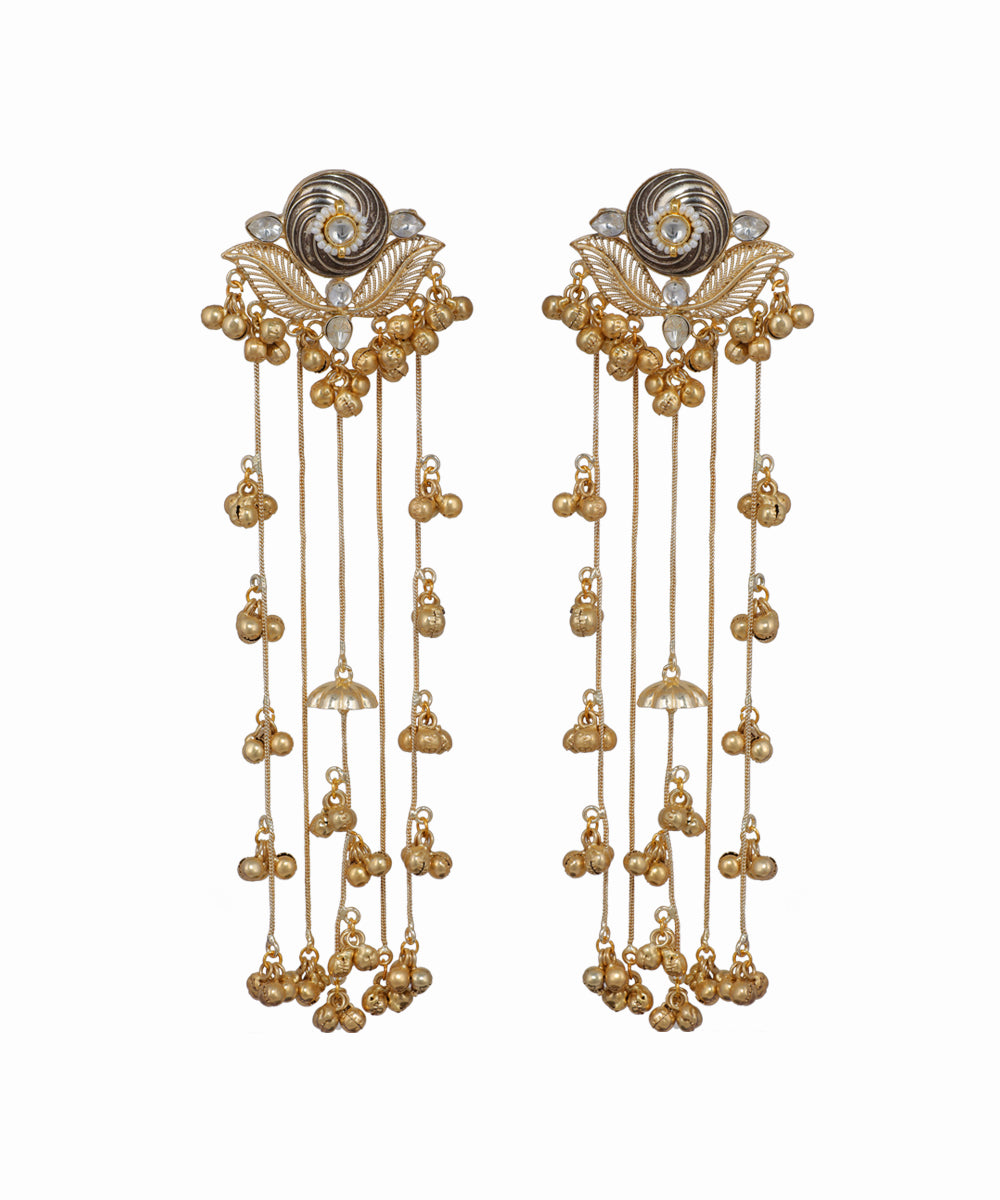 Pair of gold earrings with intricate designs on a white background