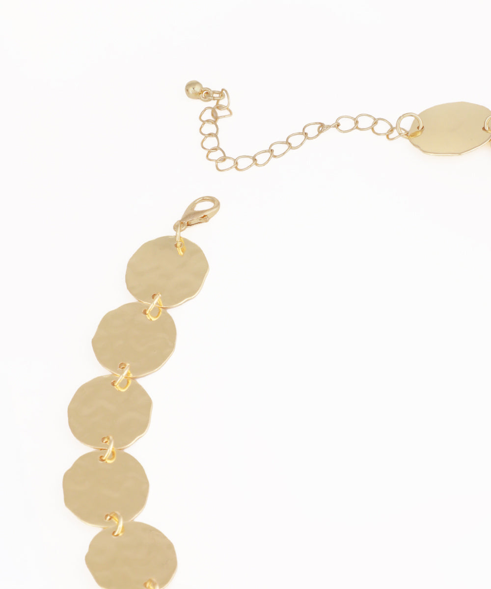 Gold bracelet with round pendants on a white background