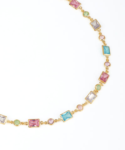 Necklace with multicolored gemstones on a white background