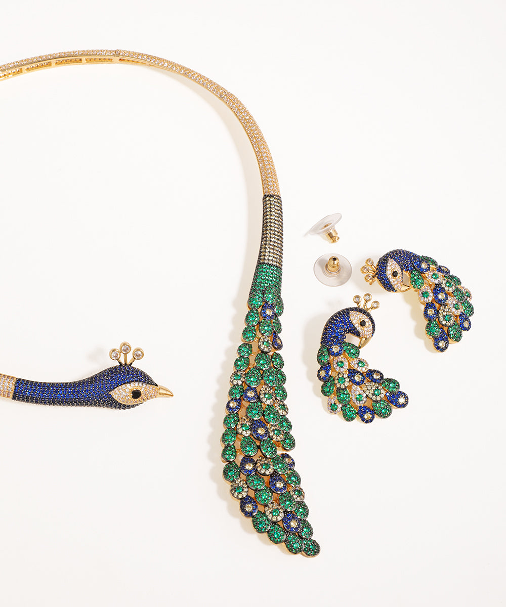 Jewelry set with peacock design on a white background