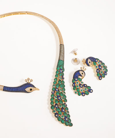 Jewelry set with peacock design on a white background