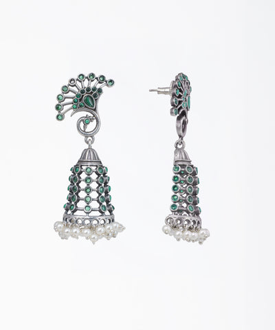 Oxidized finish jhumka earrings with peacock motif stud, green stones, and faux pearl drops