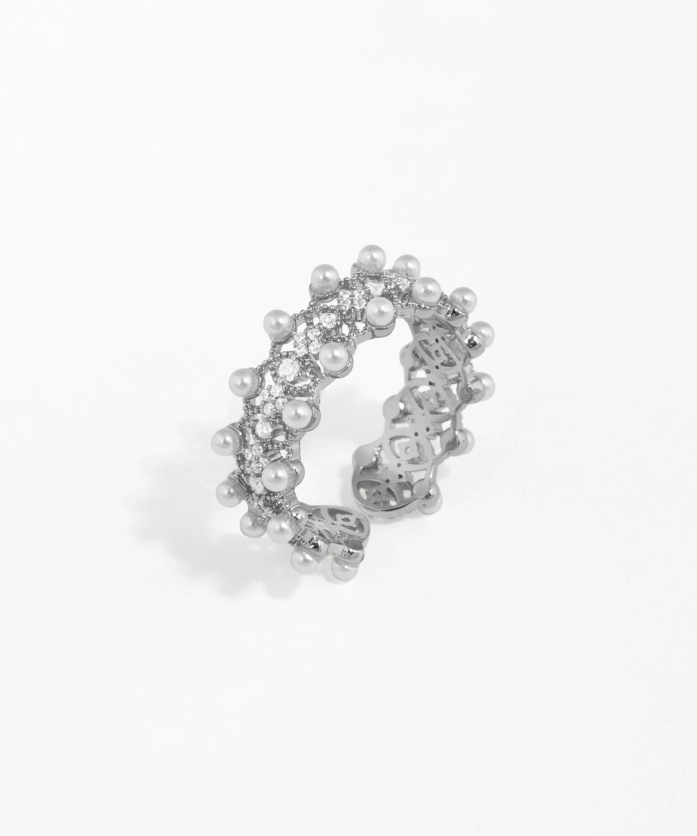 Silver ring with pearls on a white background