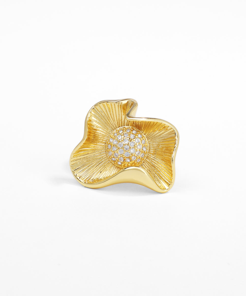 Gold brooch with diamond center on a white background