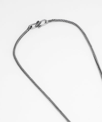 Silver chain necklace on a white background