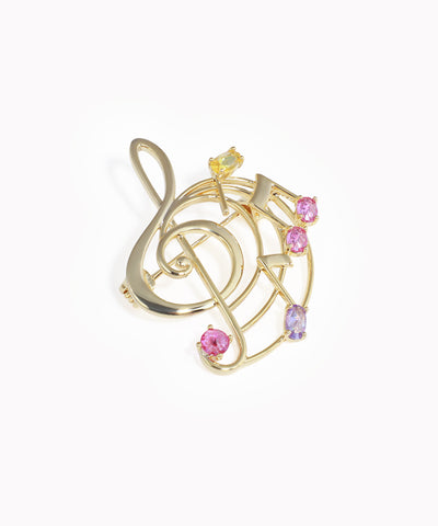 Gold-tone brooch with treble clef and colorful music note design