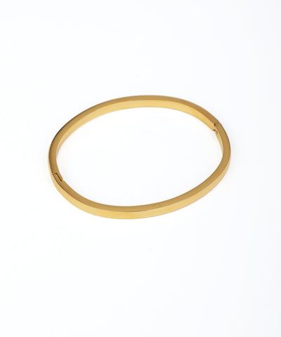 Gold bangle on a white background