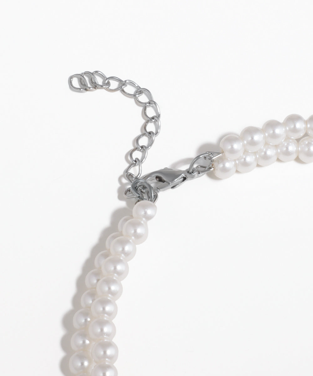 Pearl necklace with silver clasp on a white background