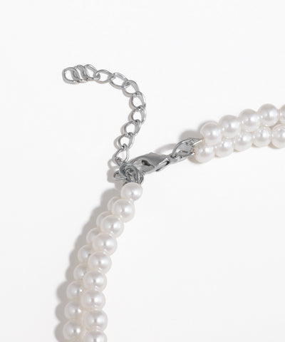 Pearl necklace with silver clasp on a white background