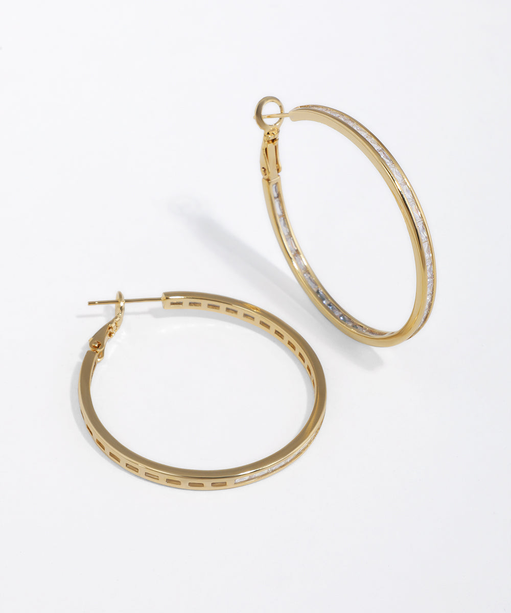Gold-tone hoop earrings with clear baguette stone detail