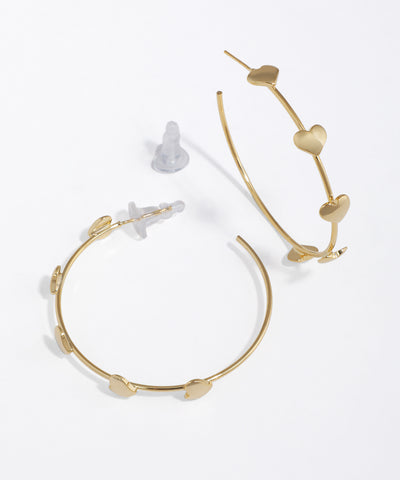 Gold-tone hoop earrings with flat, sculpted heart details and push-back closure.