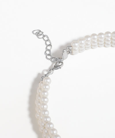 Pearl necklace with silver clasp on a white background