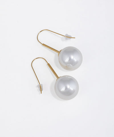 Gold-tone hook drop earrings with large, smooth faux pearl spheres