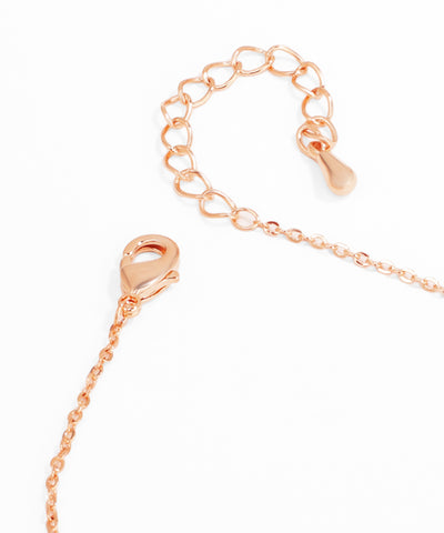 Rose gold chain necklace on a white background
