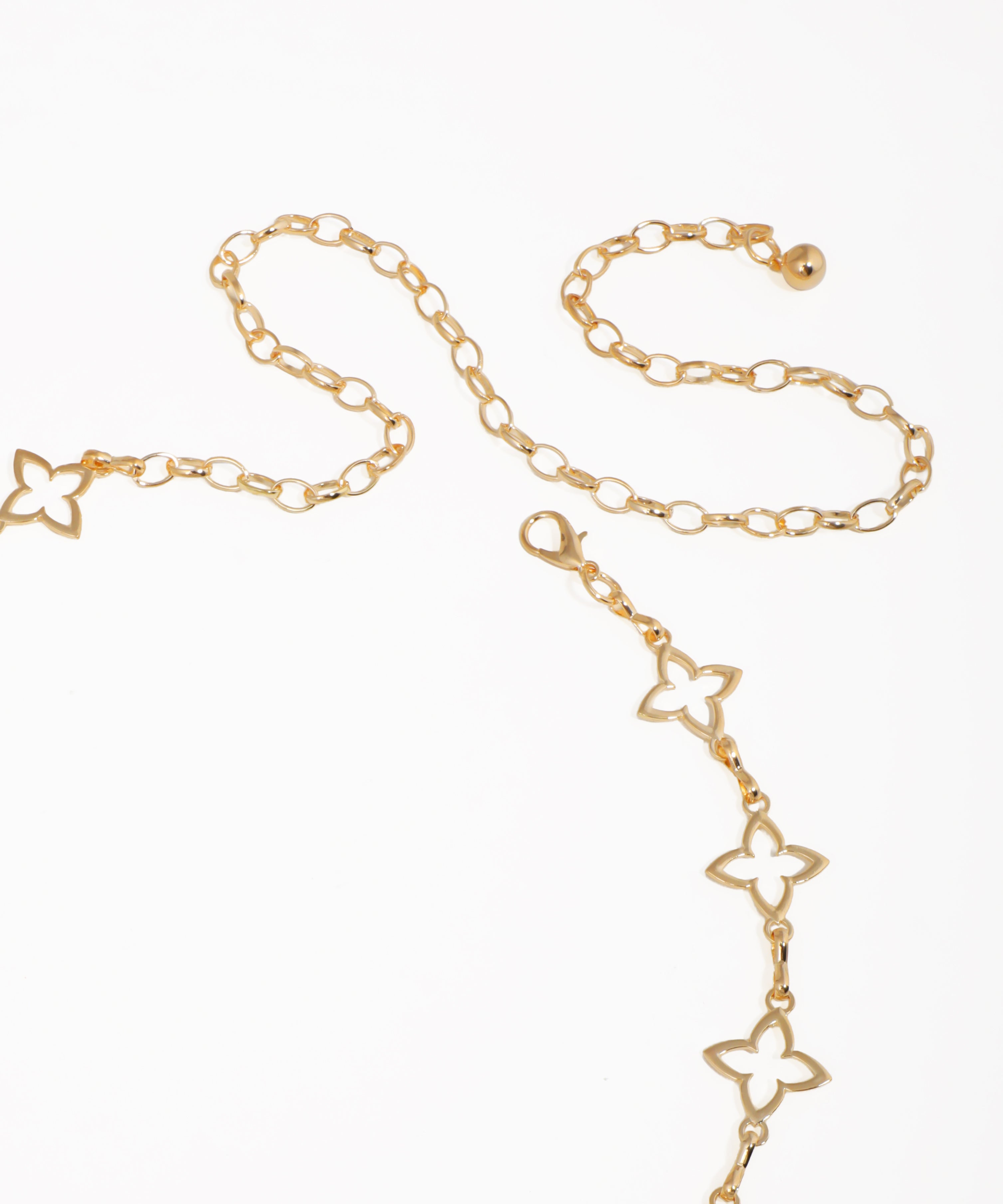 Gold chain necklace with butterfly designs on a white background