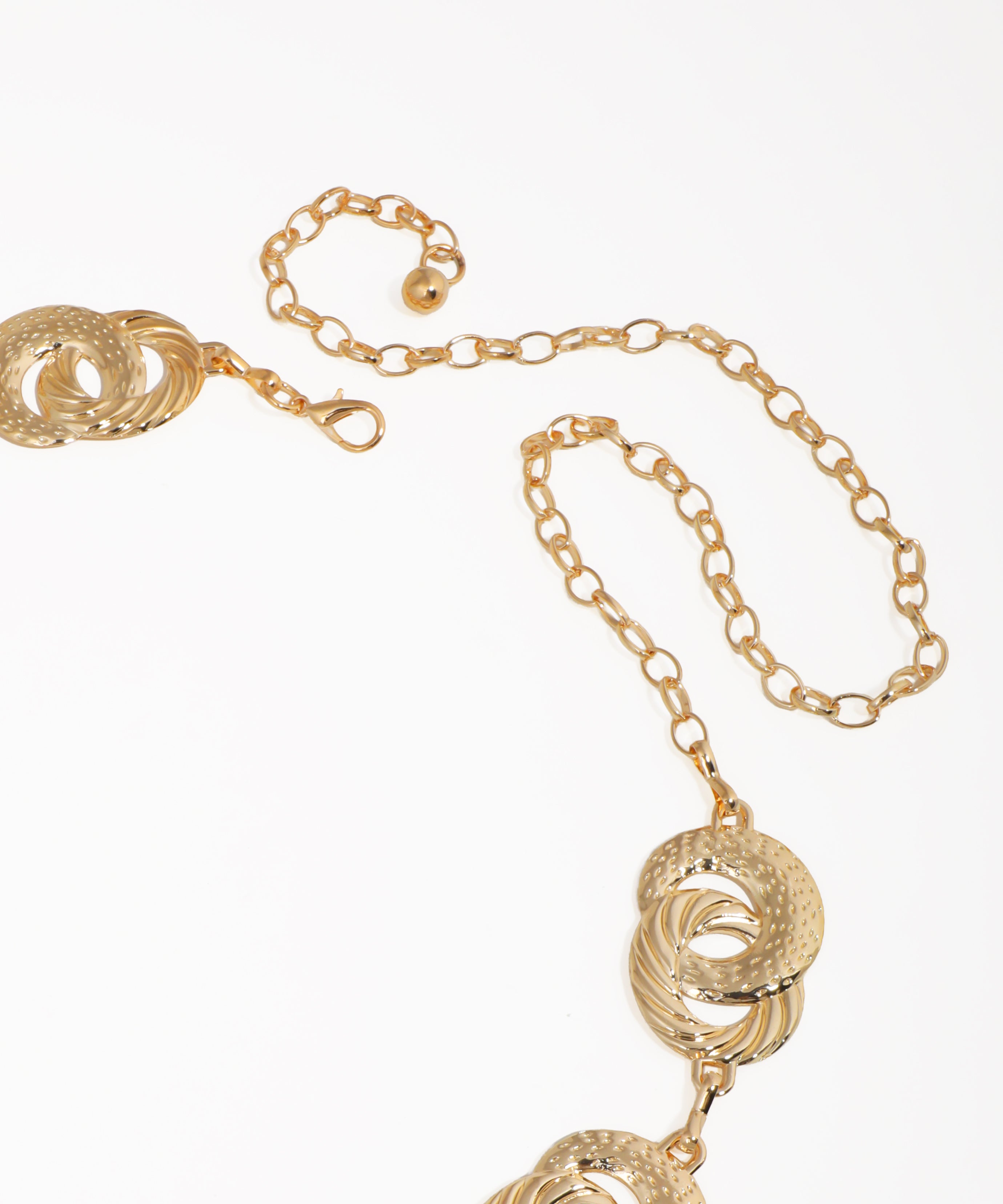 Gold necklace with intricate design on a white background