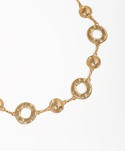 Gold necklace with circular links on a white background