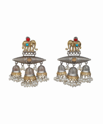 Pair of ornate earrings with elephant design on a white background