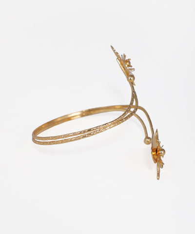 Gold bracelet with decorative elements on a white background