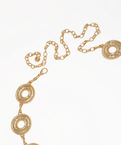 Gold chain belt with circular designs on a white background