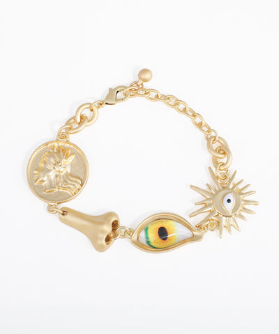 Gold-tone charm bracelet with unique coin, nose, eye, and sunburst motifs