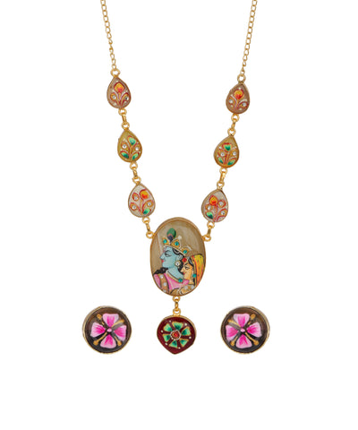 Gold-tone necklace with teardrop and oval enamel charms featuring colorful floral and Devotional art motifs, shown with matching stud earrings on a plain white background.