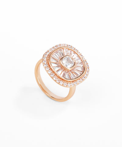 Rose gold ring with a central gemstone and diamond-studded band on a white background