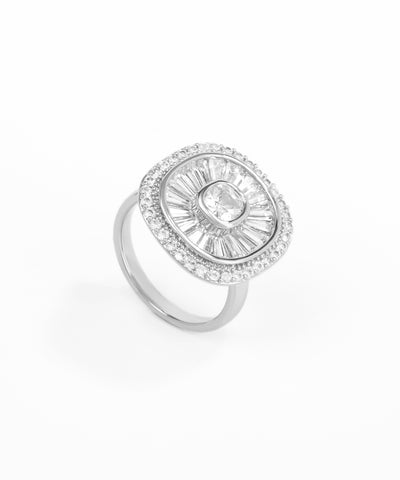 Silver ring with a central gemstone and smaller stones on a white background