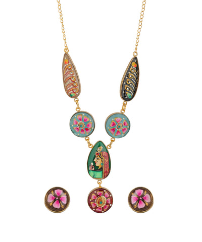 A gold-tone necklace with three drop chains, each featuring a teardrop and oval pendant with colorful floral and traditional Indian-inspired patterns, shown with three matching stud earrings on a plain white background.