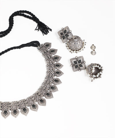 Silver necklace with black accents and matching earrings on a white background