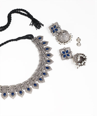 Silver jewelry set with blue stones on a white background