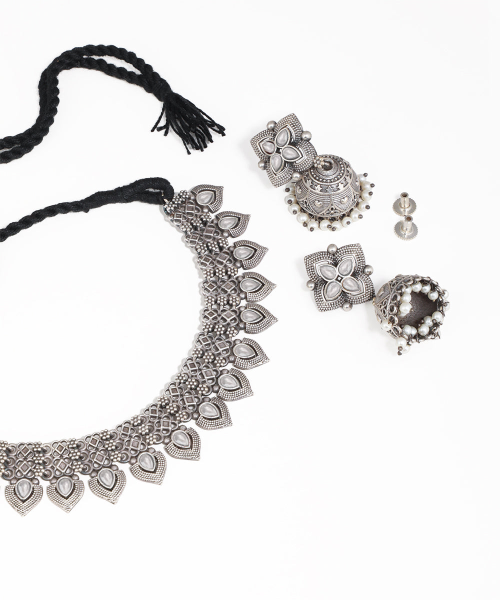 Silver jewelry set including necklace, earrings, and bangles on a white background