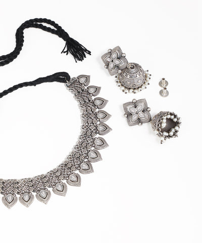 Silver jewelry set including necklace, earrings, and bangles on a white background
