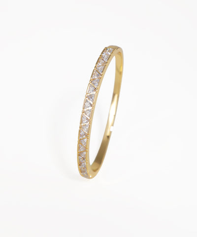 Gold ring with diamond accents on a white background