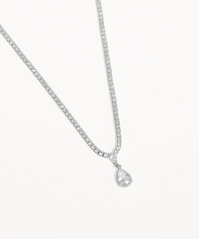 Silver necklace with a teardrop-shaped pendant on a white background