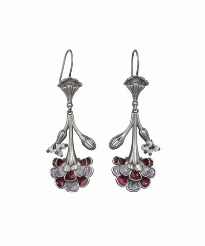 Pair of silver earrings with red gemstones on a white background