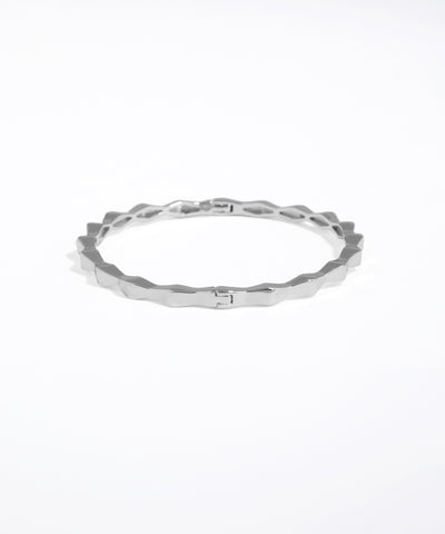Silver ring with a textured band on a white background
