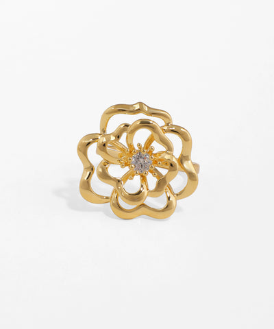 Gold flower-shaped ring with a diamond on a white background