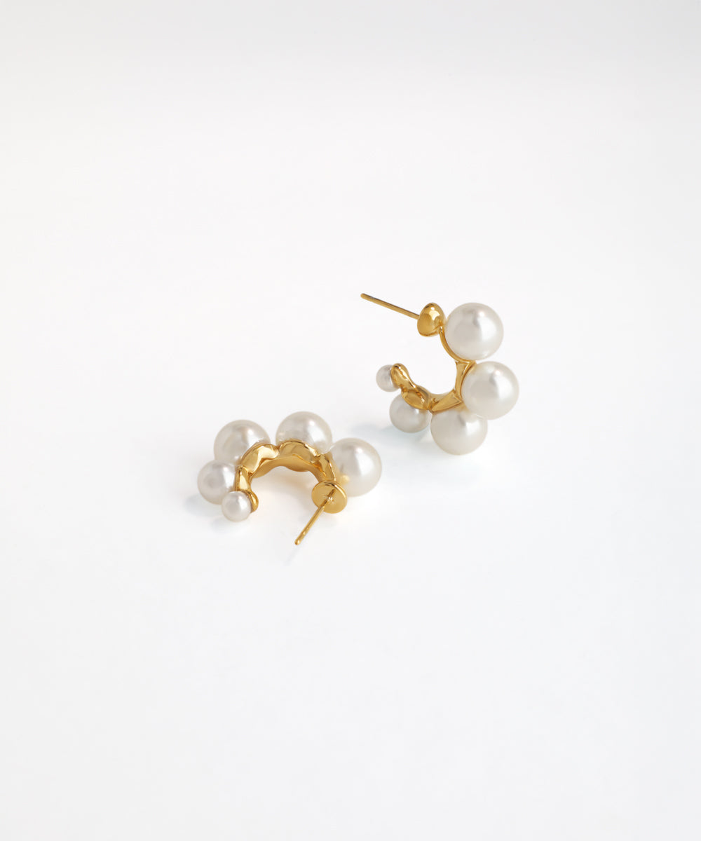 Pair of pearl earrings with gold posts on a white background
