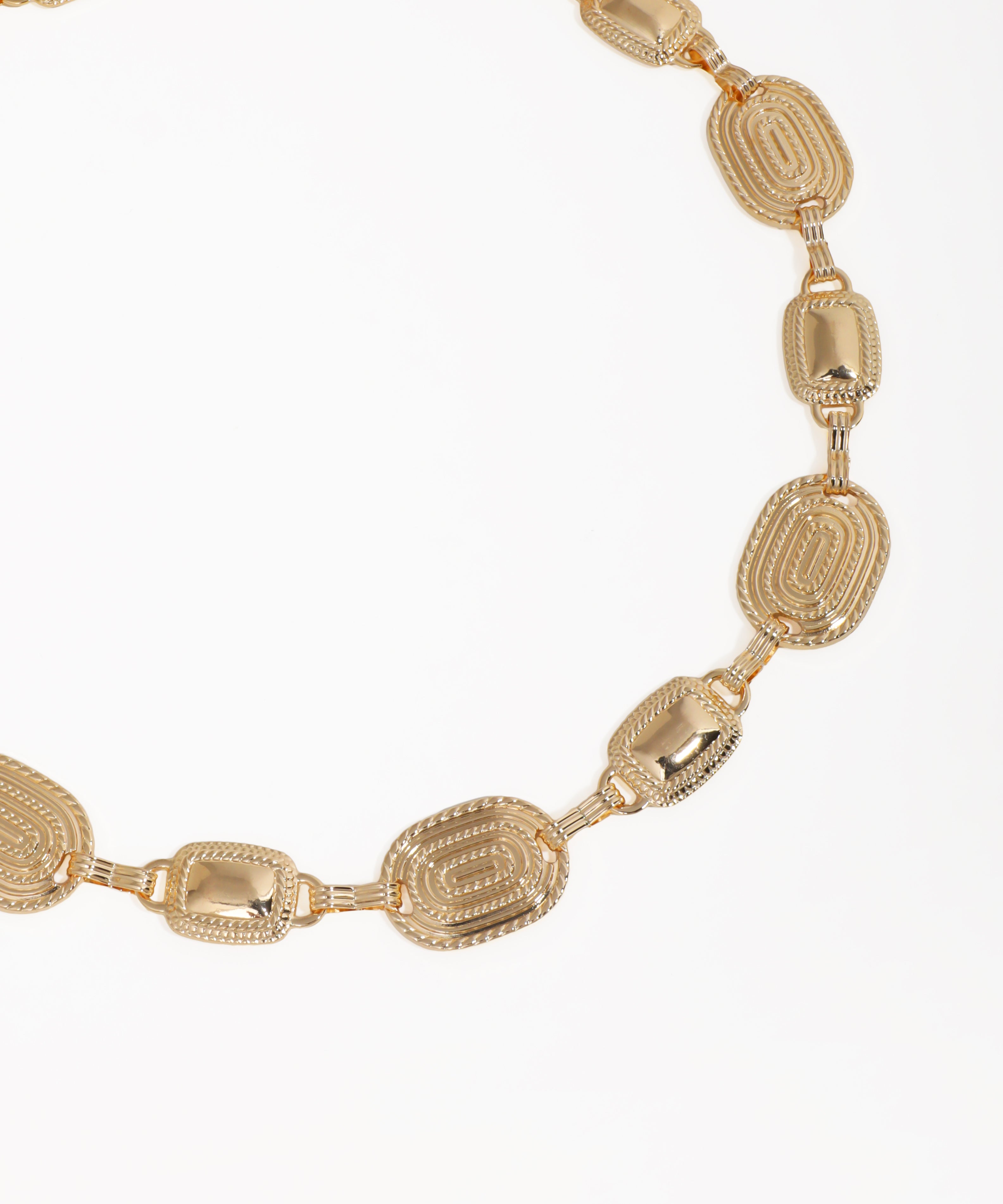 Gold necklace with intricate design on a white background
