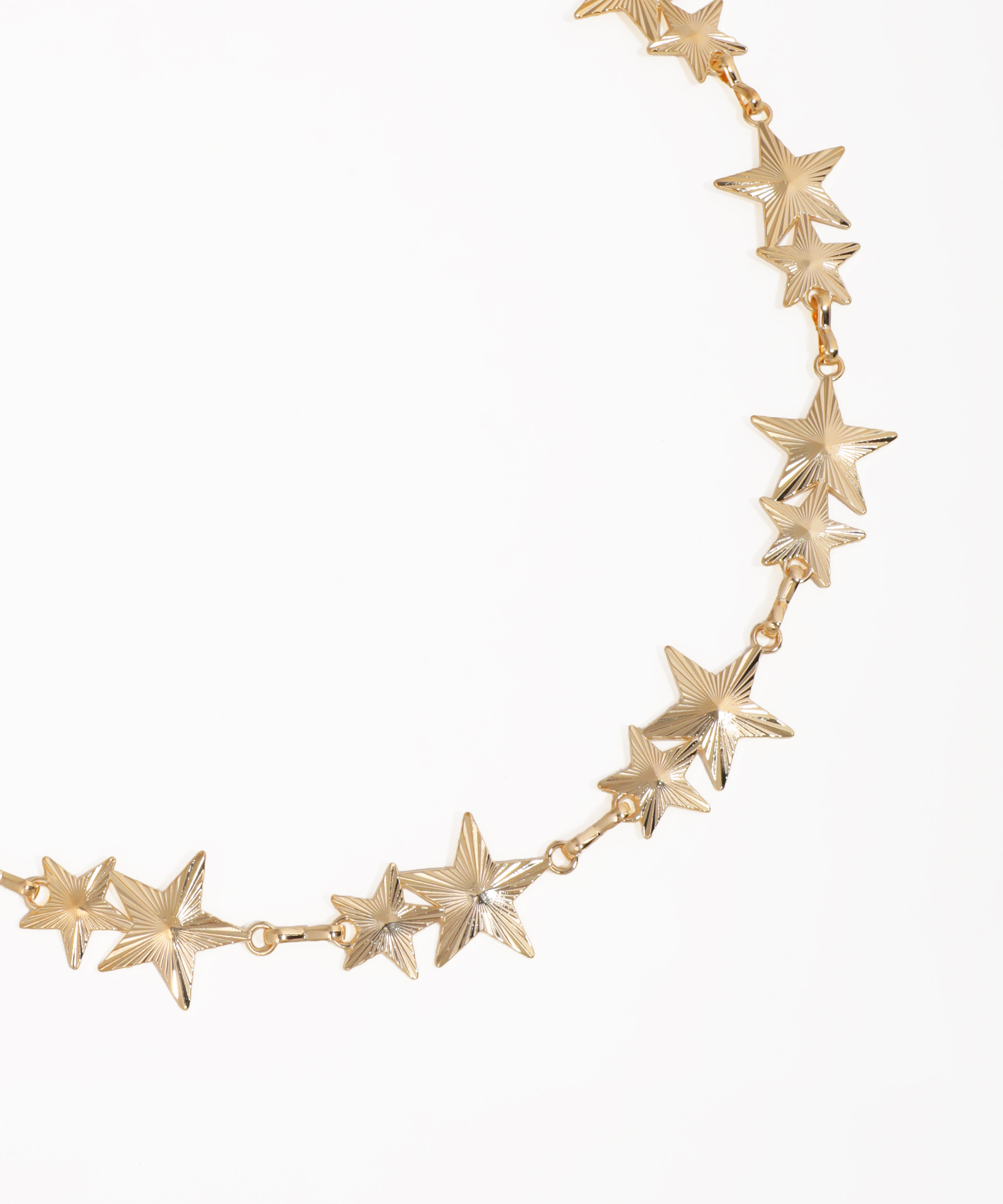 Gold star-shaped necklace on a white background