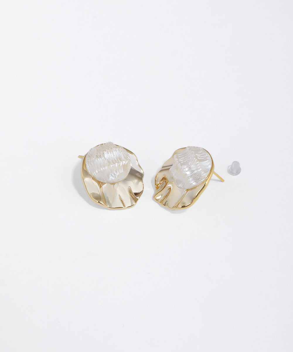 Gold-tone stud earrings with wavy metal base and textured, translucent dome